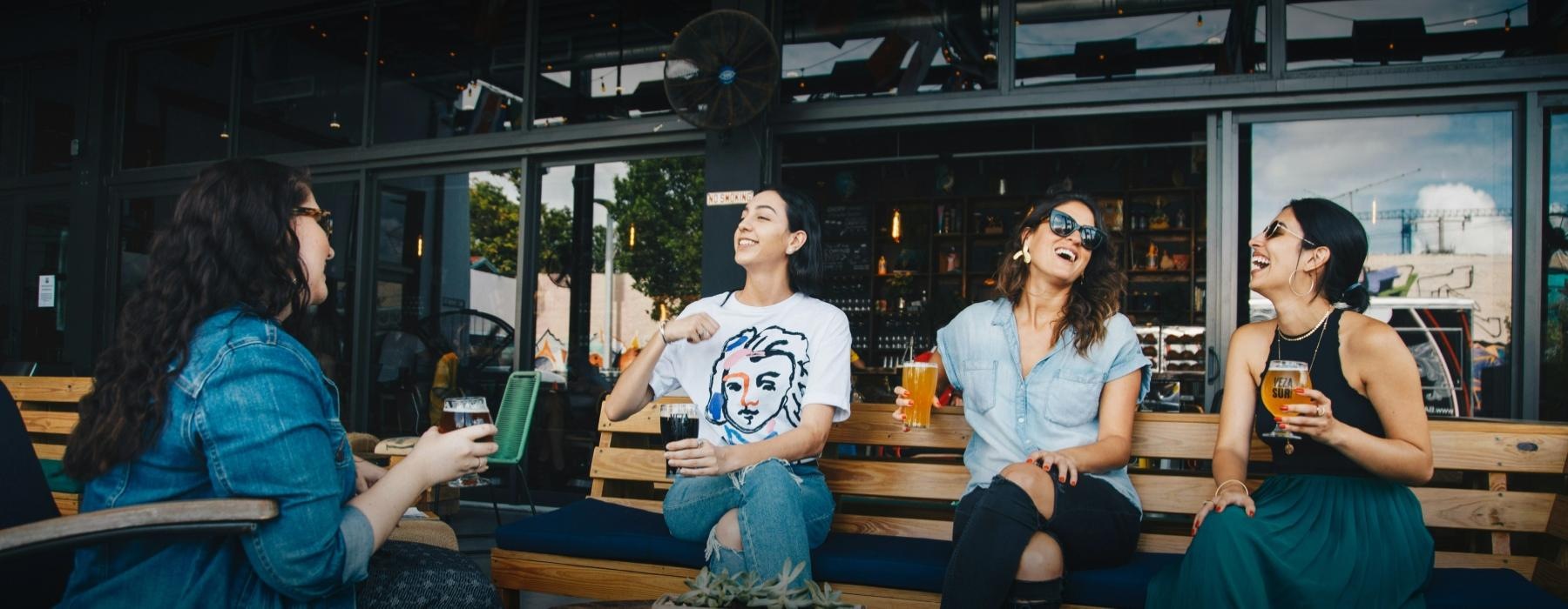 a group of people sitting at a table with drinks